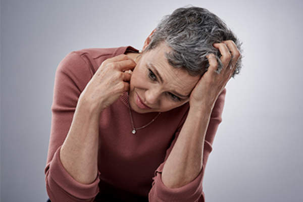 Woman with anxiety and itchy skin.