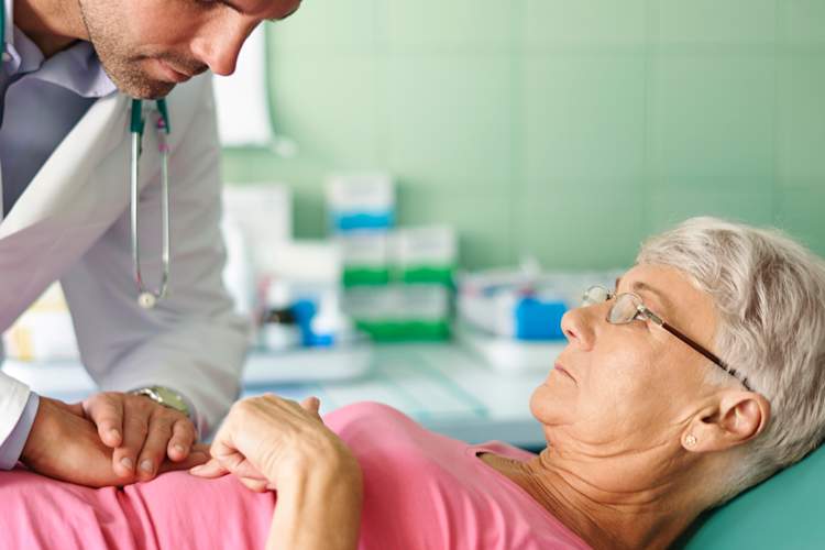 A doctor examines a woman's stomach.