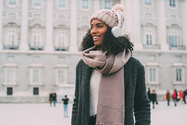 Woman walking around a city outdoors in winter.