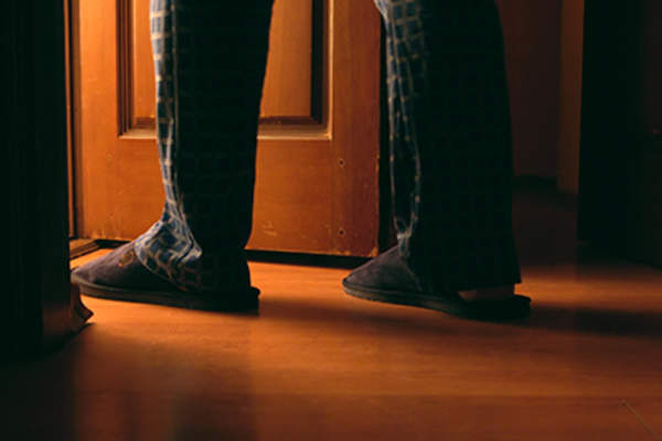 Man walking to the bathroom at the night.