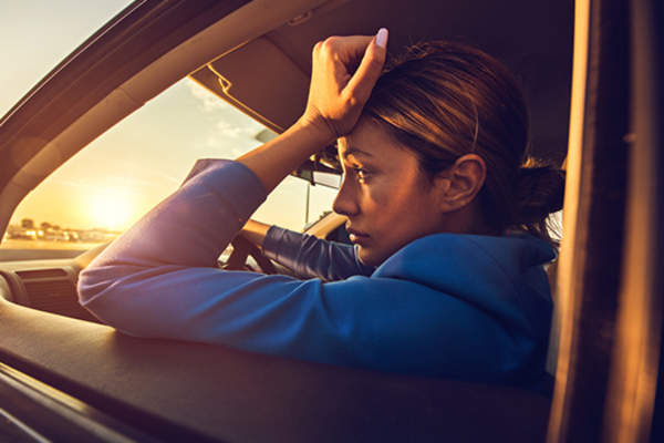 worried woman in the car image