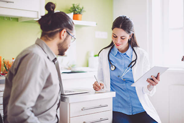 Man talking to a doctor about his psoriasis diagnosis.