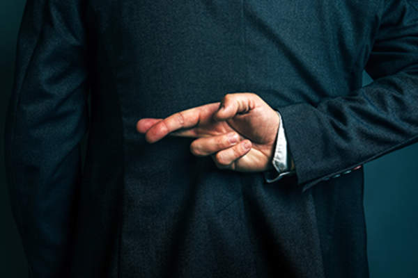 Lying businessman holding fingers crossed behind his back.