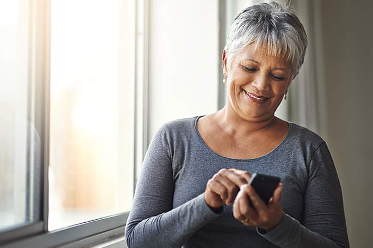 Senior woman checking her phone reminders.