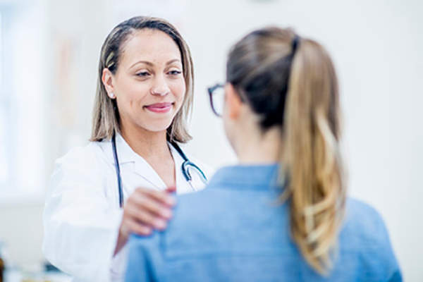 Woman discussing her psoriatic arthritis anxiety with a dermatologist.