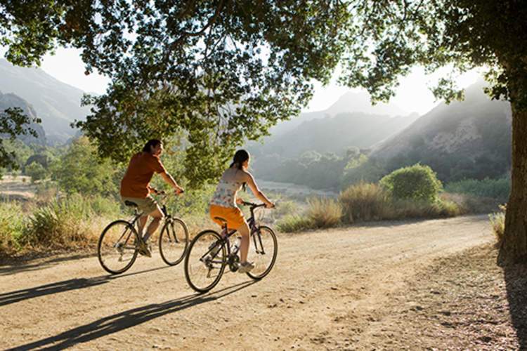 Active couple biking on scenic road