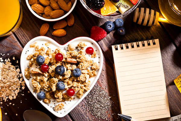 Dieting concept: heart shaped bowl with yogurt and cereal