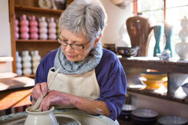 Potter making clay pot.
