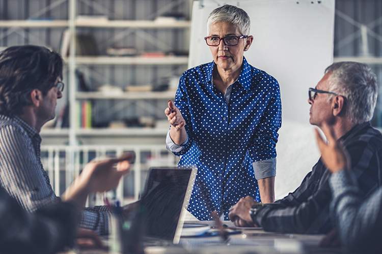 Businesswoman leading a meeting in an office.