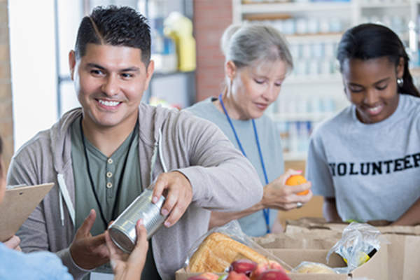 Happy man volunteering and food bank.