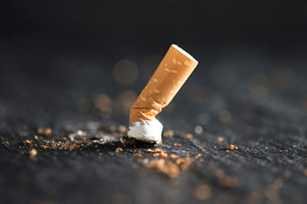 Putting out cigarette.