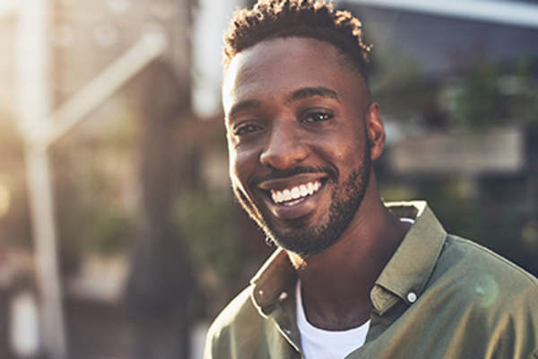 Man smiling outdoors.