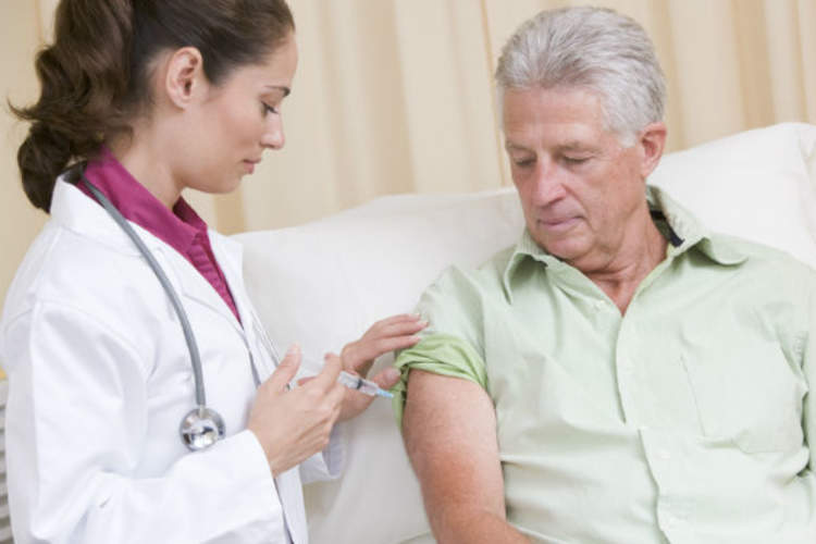 Doctor giving man Vaccine
