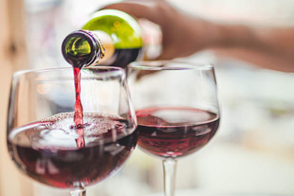 Pouring glasses of wine.