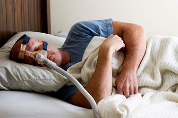 Man sleeping with a CPAP.