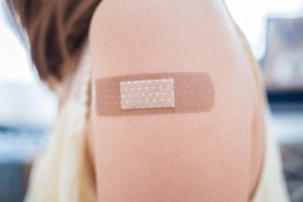 bandaid on woman's arm