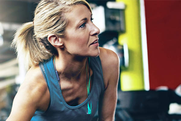 Woman sitting and stretching at the gym.