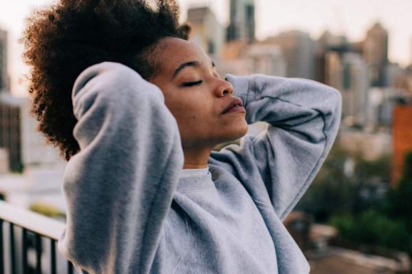 woman with eyes closed head tilted up