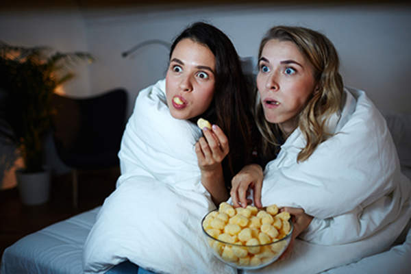 Women snacking together at night.