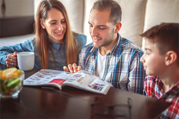 Family looking at a catalog.