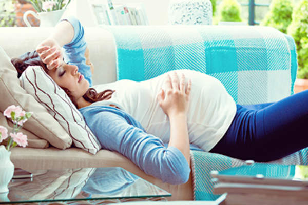 Pregnant woman resting on the couch.
