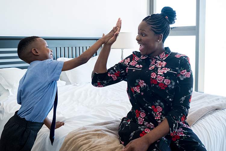 Mother and son high five, ready.