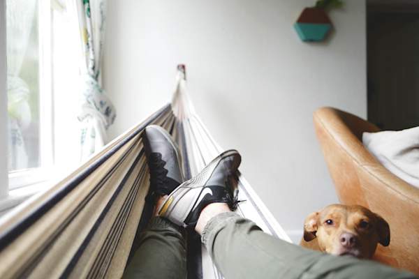 feet elevated on indoor hammock