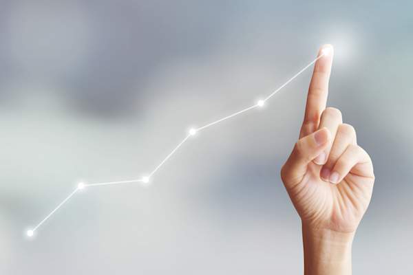 Woman's finger showing increasing rates on a graph.