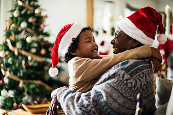 Grandparent and grandchild hugging on Christmas.