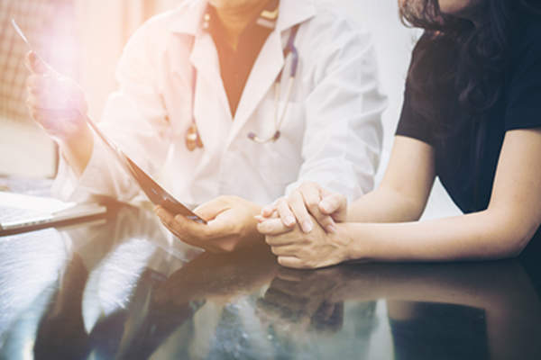 Woman talking to her doctor about her diagnosis and treatment plan.
