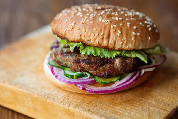 Classic american burger, fast food on wood background