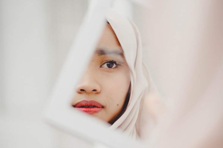 woman looking in mirror