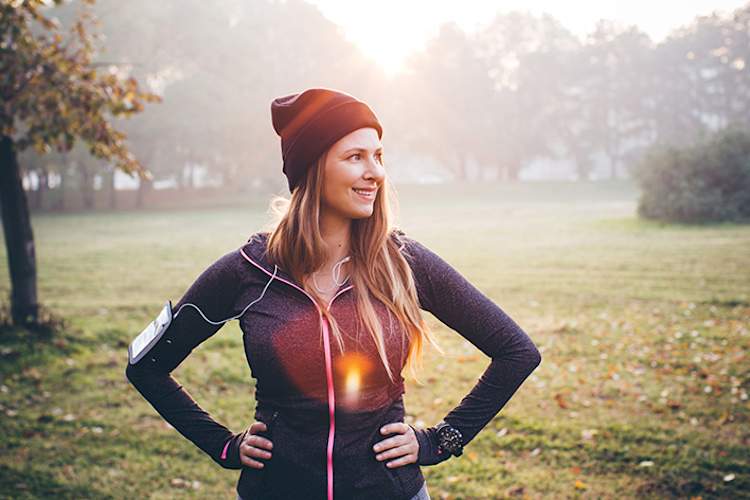 Woman going for a jog outdoors in the winter to combat seasonal anxiety.