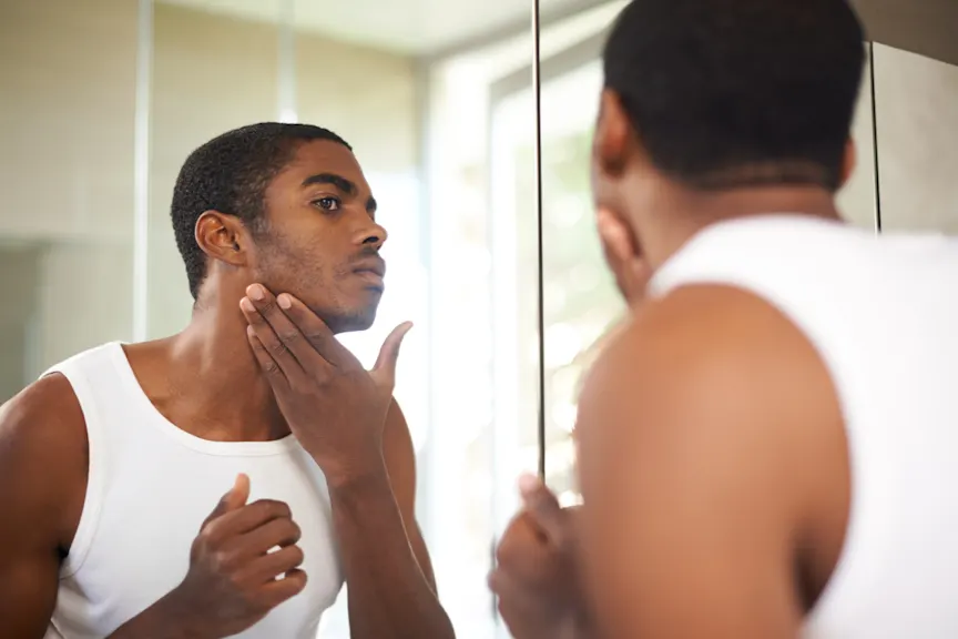 Man looking in the mirror.