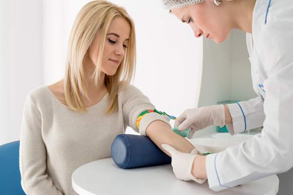 Young woman having a blood test.