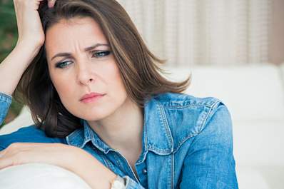 Stressed woman experiencing the symptoms of early menopause.