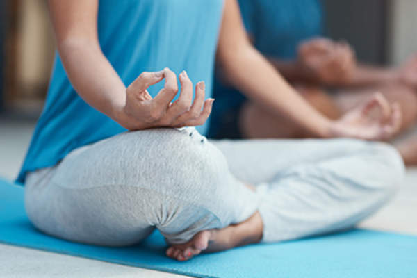 Meditating on a yoga mat.