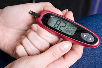 Woman Checks Her Blood Sugar