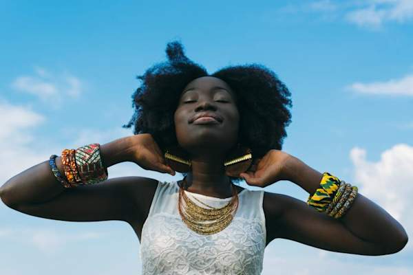 serene happy woman against blue sky