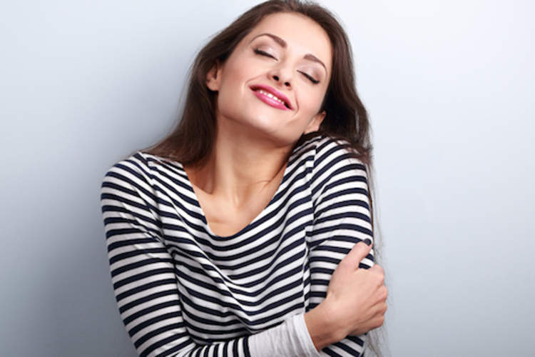Woman hugging herself.