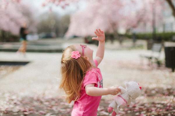 little girl reaching up