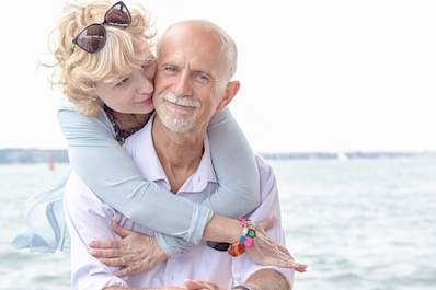 Senior couple embracing near the ocean.