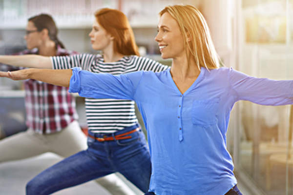 Women doing tai chi in office.