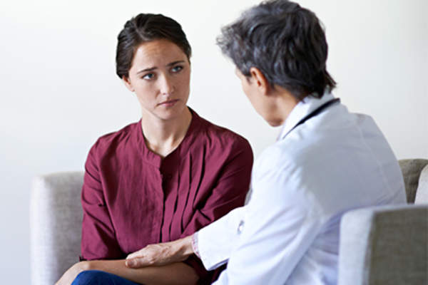 Concerned woman talking to her doctor.