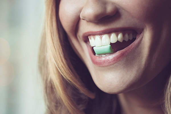 Woman with chewing gum in her mouth.