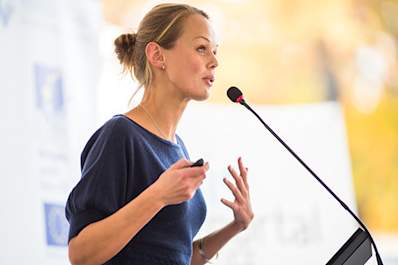 Young woman giving a presentation image.