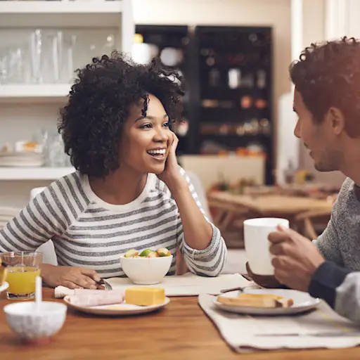Spouses talking at breakfast.