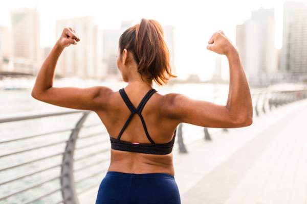 woman flexing arms outside