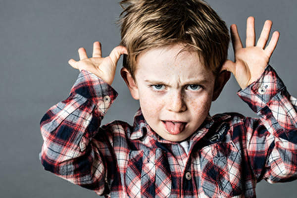 Misbehaving child making faces.
