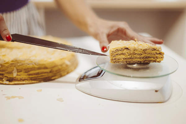 Weighing a portion of pie.
